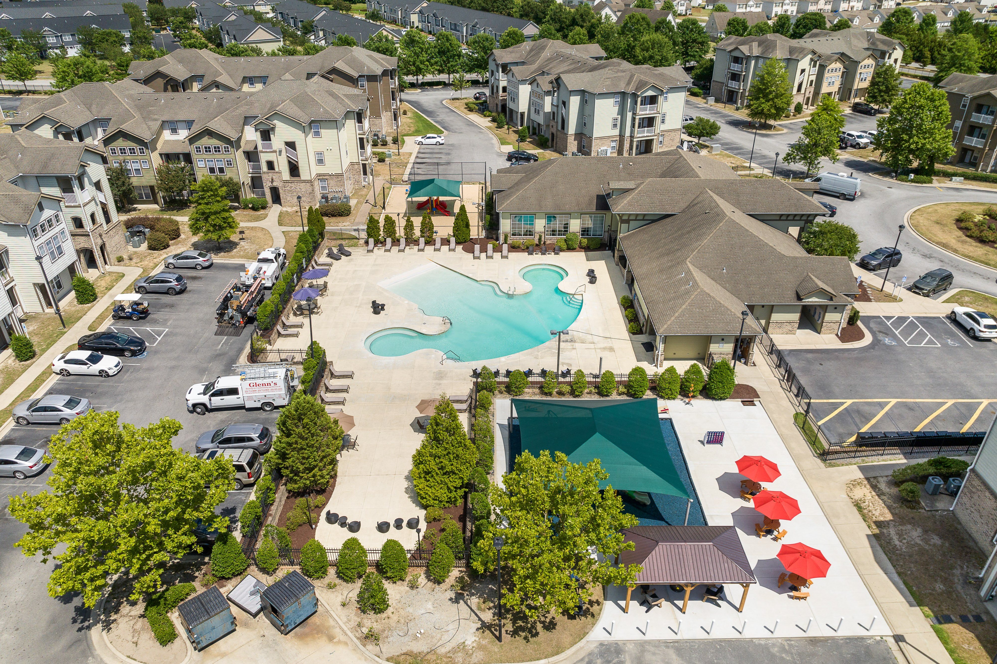 an aerial view of an apartment complex with a swimming pool
